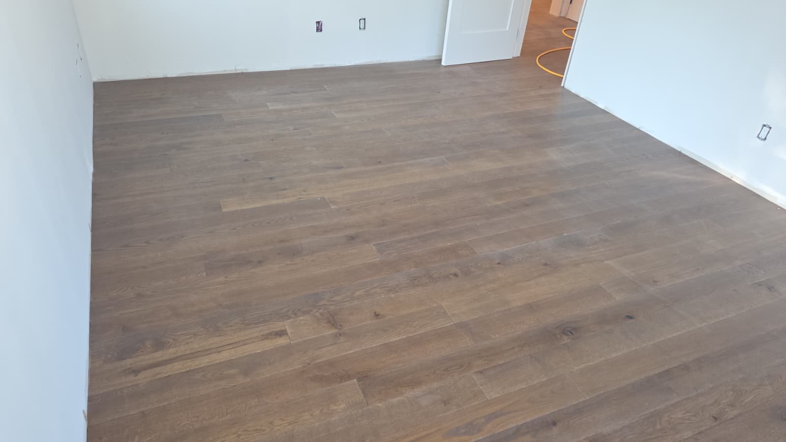 Modern gray-brown engineered oak floor in a finished room
