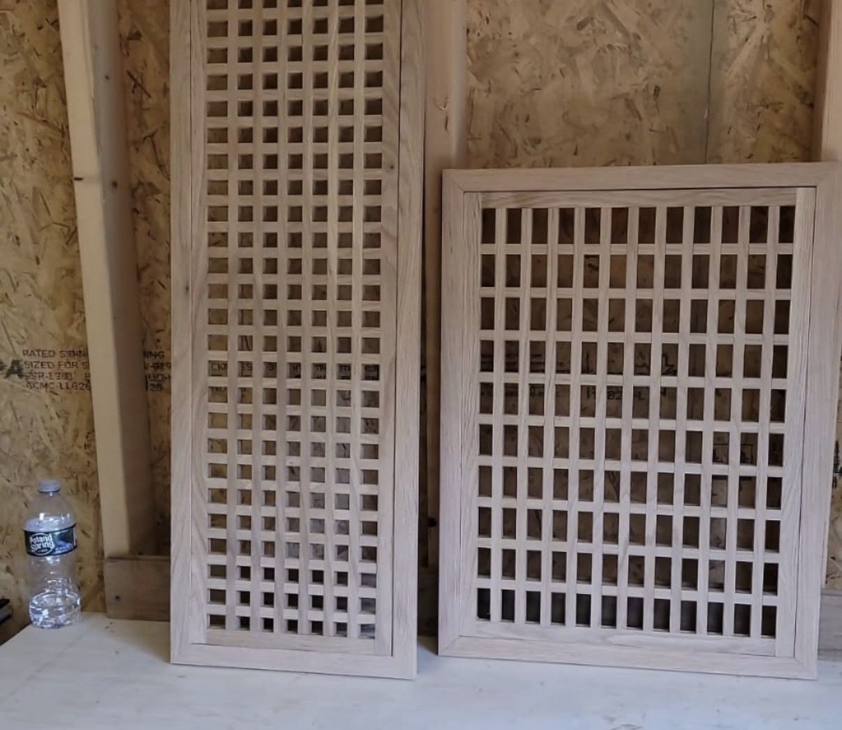 Two oversized custom lattice wood grille panels